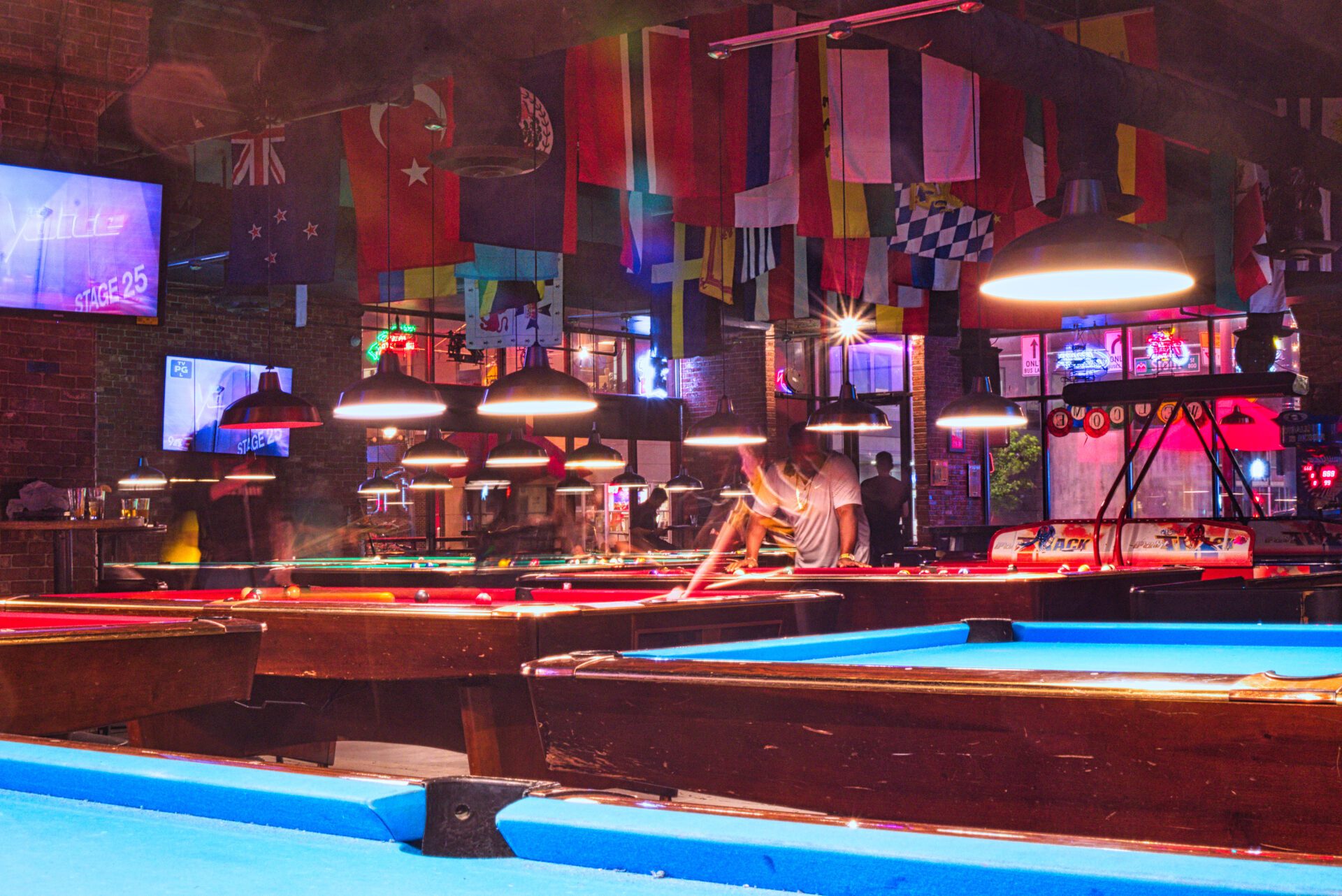 closeup of billiard tables with people and country flags